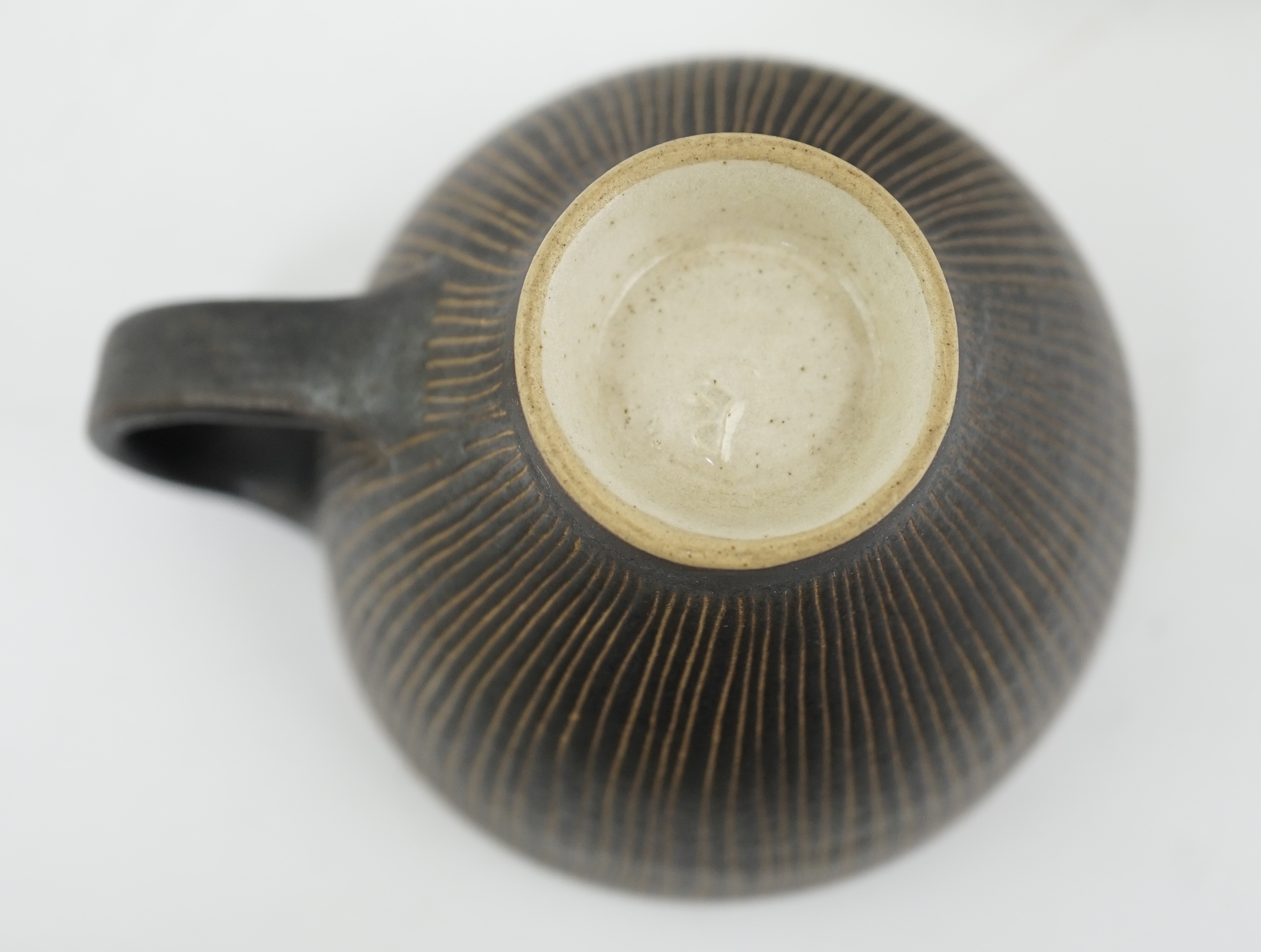 Dame Lucie Rie D.B.E. (1902-1995), a manganese glazed coffee cup and saucer